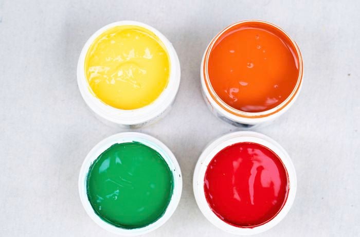 A selection of bold paint colours used to create a colourful throwback mirror makeover inspired by retro interiors and bold decorative styles.