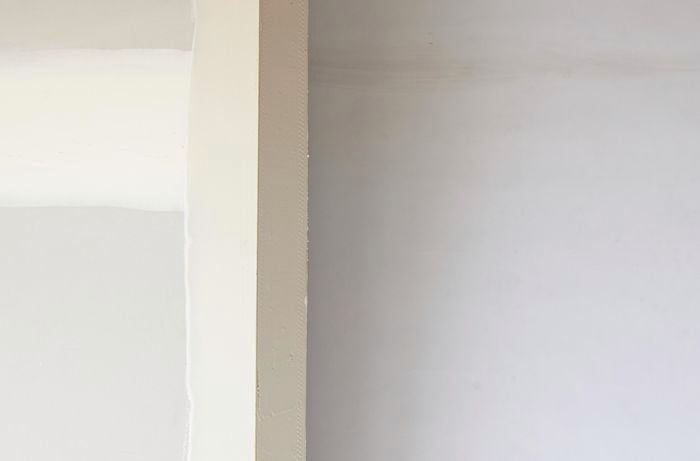 Plastered wall edge, with external angles just visible.