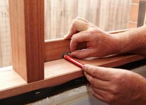 Person marking position of stays on a casement window
