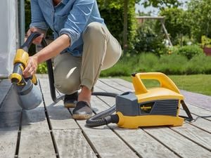 Wagner
  Flexio W690 with standard spray attachment used to spray dark gray paint to
  outdoor decking