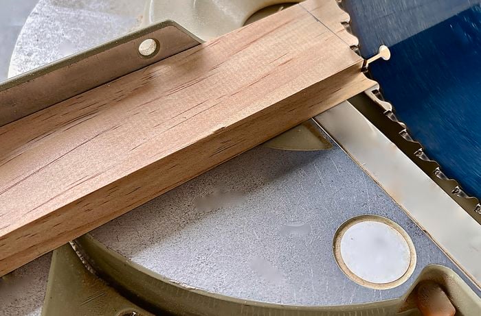 Mitre saw cutting a piece of pine.