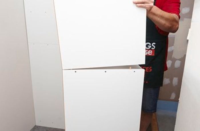 Placing the top unit onto the bottom unit.