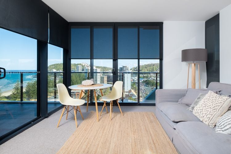 Seaside apartment with shade blinds partly covering four windows