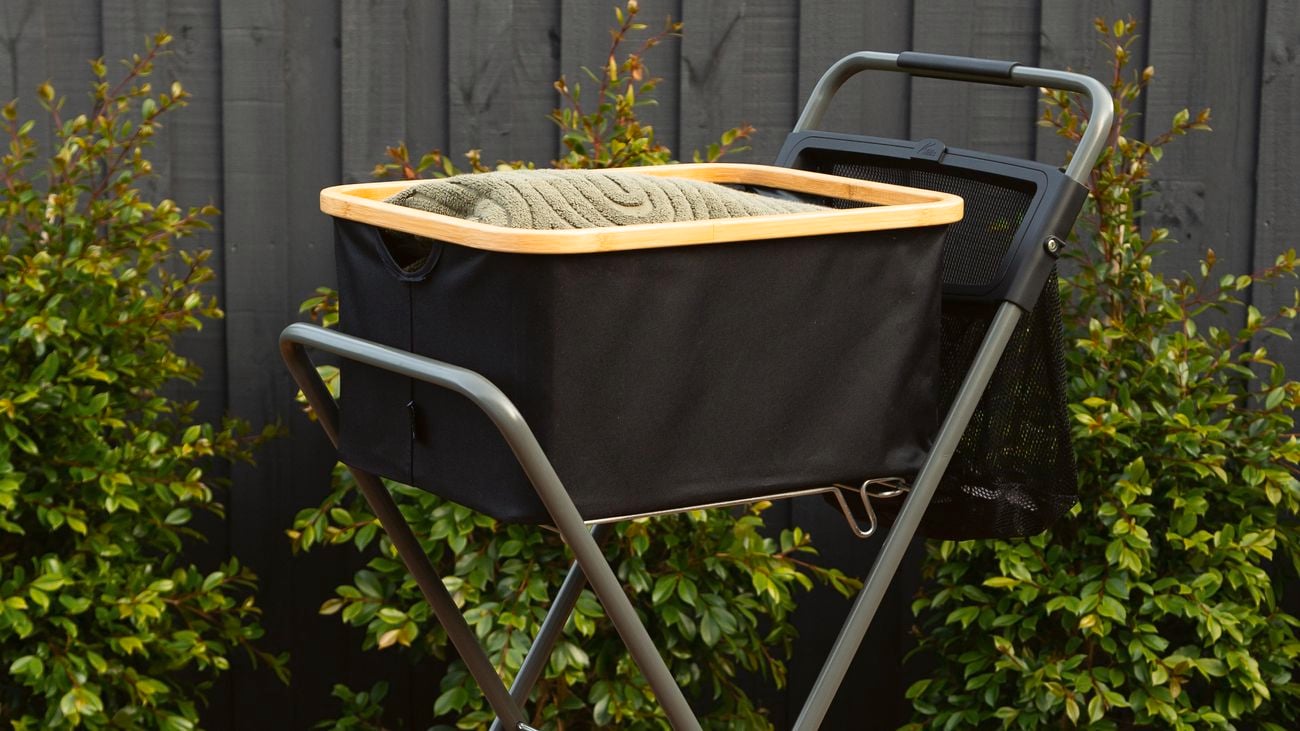 Hills foldable bamboo laundry basket in black on a laundry trolley