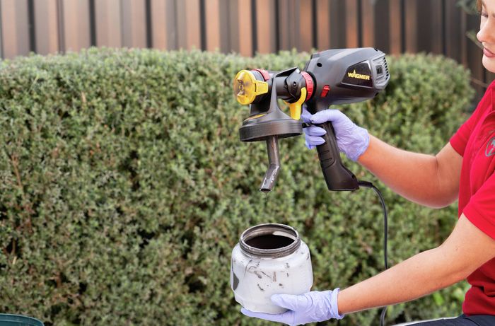 Bunnings Team Member cleaning a paint spray gun