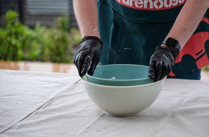 placing a smaller bowl into a larger bowl