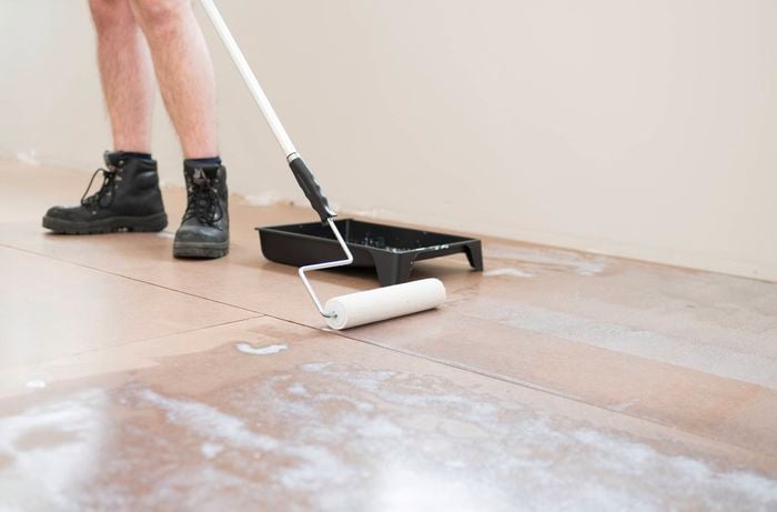 Apply floor primer with a floor roller