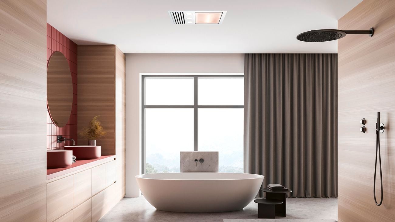Freestanding bath, shower, mirror on the wall and two basins on cupboards in a bathroom