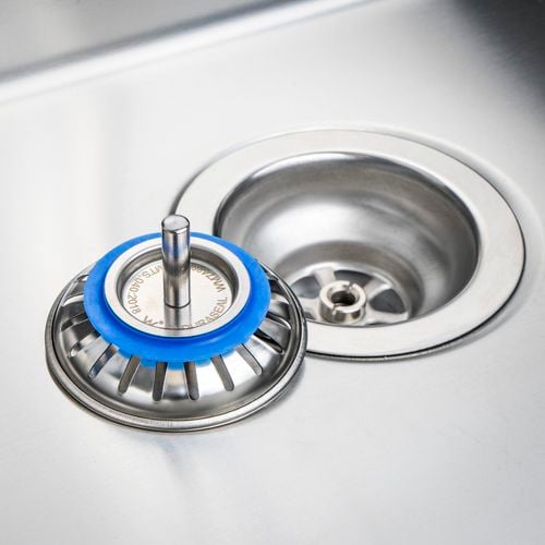 A close up of a disconnected sink strainer.