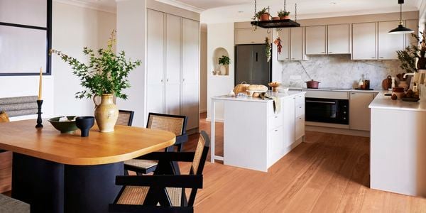 Kitchen with white cabinetry and a black table dining 