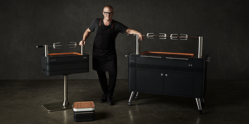 Heston Blumenthal posing beside Everdure BBQs