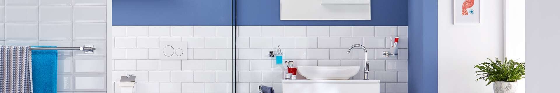 Bathroom interior with toilet, sink and sink mirror as well as tesa adhesive accessories