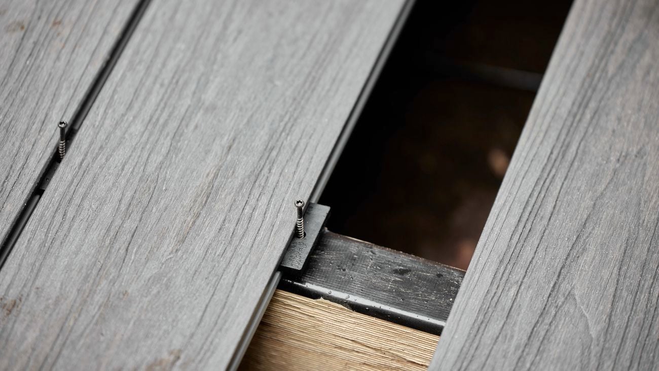 Black, deck boards laying flat on attached together with clip