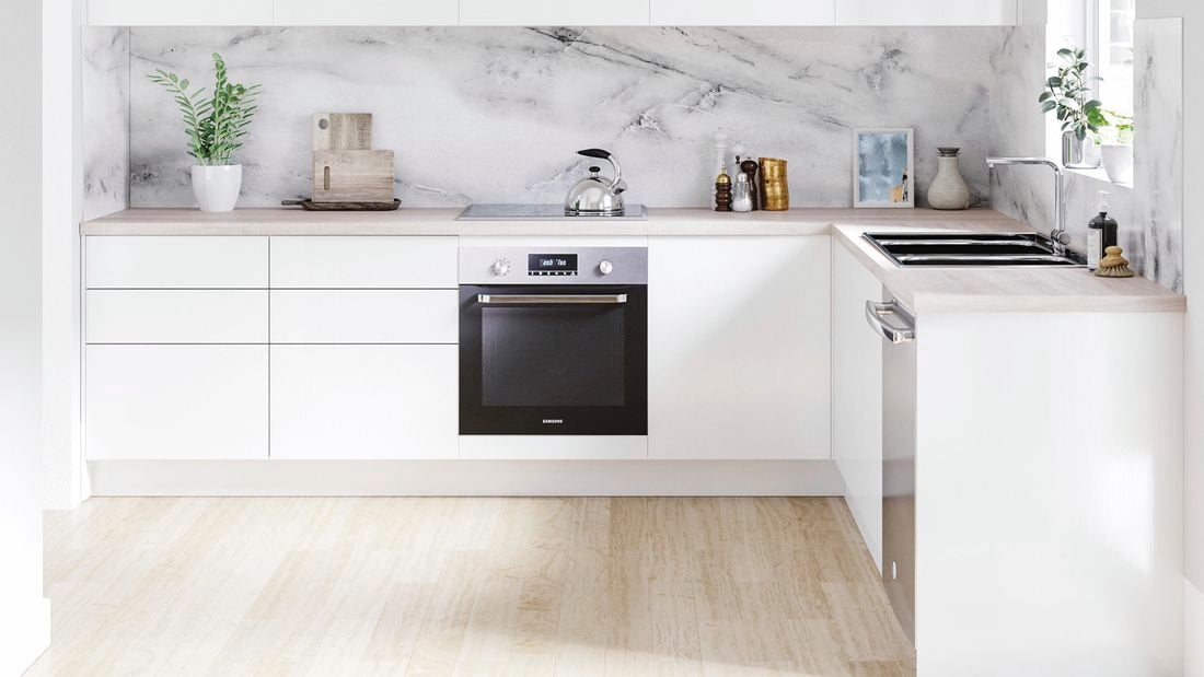 Kitchen with white and timber cabinets, timber benchtop and marble splashback.