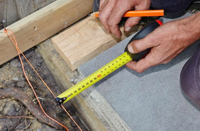 Person measuring timber.
