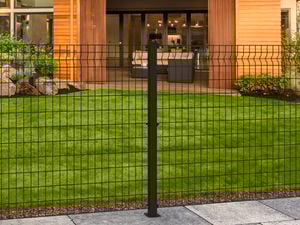 Black wire grid fence at the front of a house