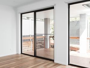 View from inside of house of sliding doors leading out to deck.