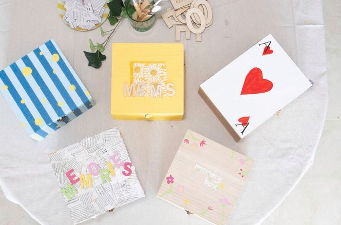 A collection of decorated memory boxes shows how painting the base colour creates the foundation for creative DIY memory box designs