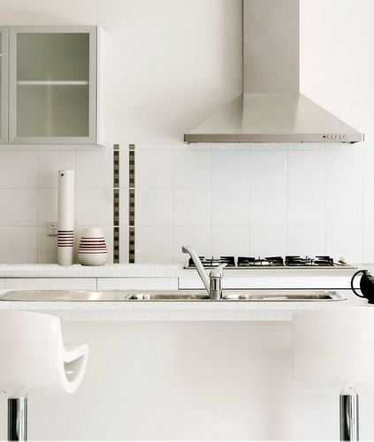 White kitchen stools at a white island bench with sink insert 