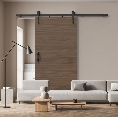 Living room interior featuring Rolltrak Matte Black Arrowhead Side Mount Barn Door Track and Matte Black Raised Handle.