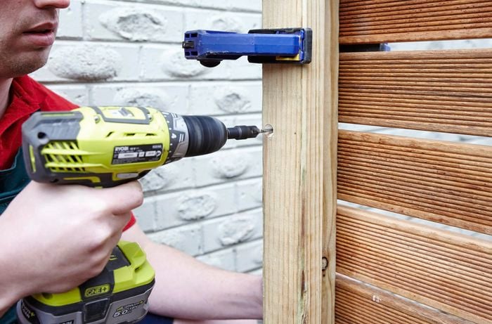 Person drilling timber together.
