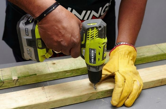 A loop being drilled into place in a piece of wood