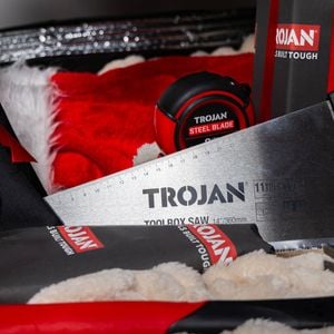 Trojan hand tools including saw, tape measure, and hammer displayed with red and black accents.