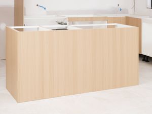 The image shows a nearly completed kitchen island bench cabinetry in a kitchen under construction.