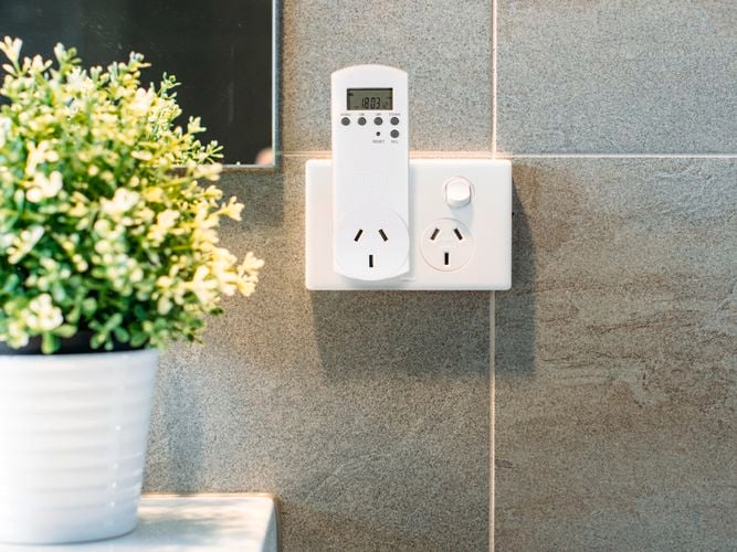 Digital outdoor timer plugged into wall
