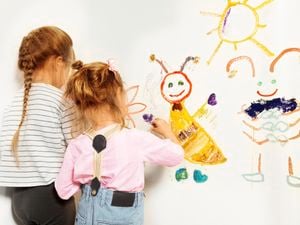 children drawing on a wall