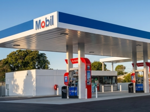 Modern Mobil petrol station with multiple fuel pumps under a large blue and white canopy.