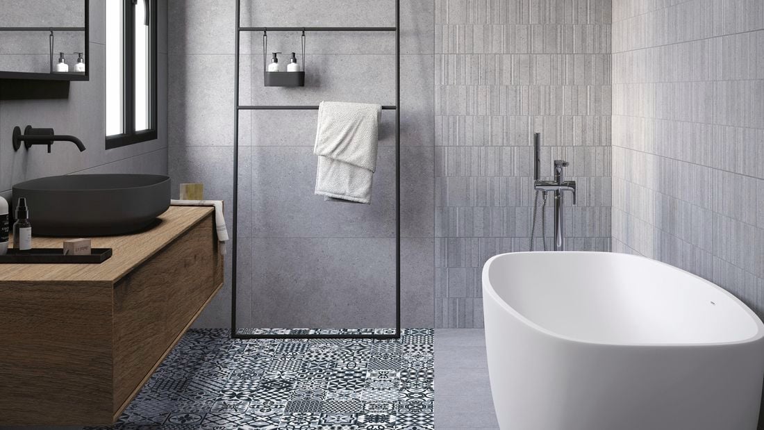 Bathroom with dark tiles and and spanish pattern on floor