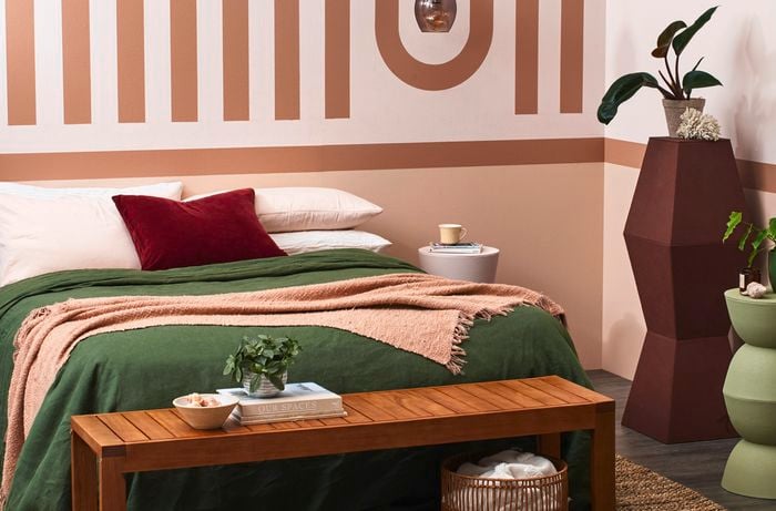 Bedroom with earthy tones and a geometric feature wall