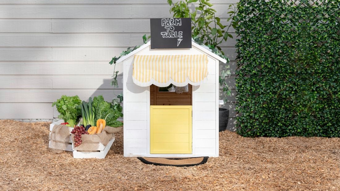 A finished cubby house customised to look like a greengrocer, pictured from the front