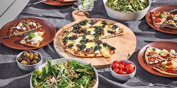 Table set with pizza and salad
