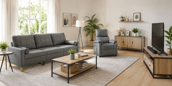 Living room featuring a grey fabric sofa, matching recliner chair, timber-look furniture, indoor plants and a bright modern interior.