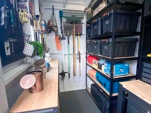 Garage interior with lots of storage boxes piled up together.