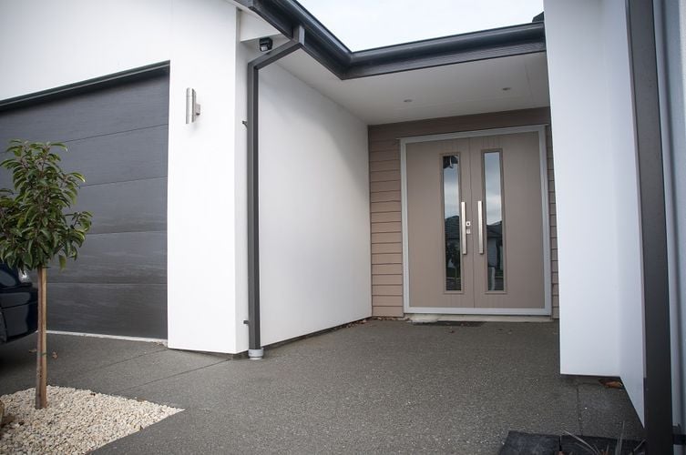 Front entryway to home with large double door painted grey