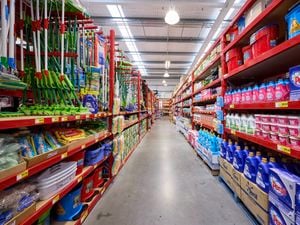 An aisle in a Bunnings store filled with cleaning products.