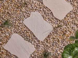 Garden dune sandstone stepping stones in gravel in garden