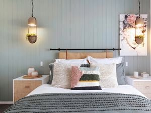 A grey themed bedroom with a panelled feature wall