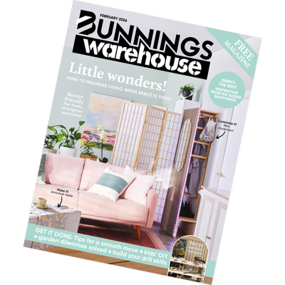 A tilted view of the Bunnings Warehouse February 2026 magazine cover featuring a compact living room and small‑space storage solutions.