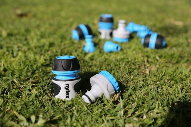 Various hose fittings on grass