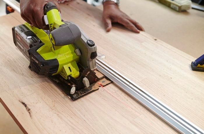 Person using circular saw to cut hardwood