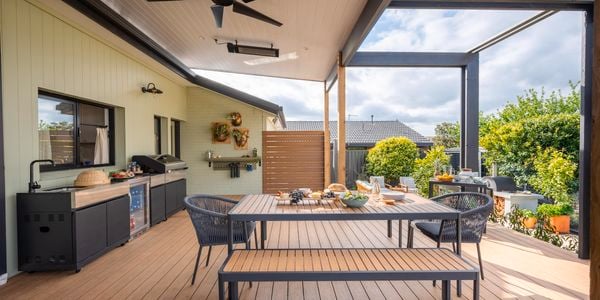 Outdoor entertaining area with an outdoor table, chairs, BBQ and a ceiling fan