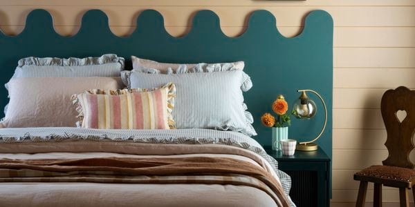 Wavy headboard in blue behind a bed for effect 
