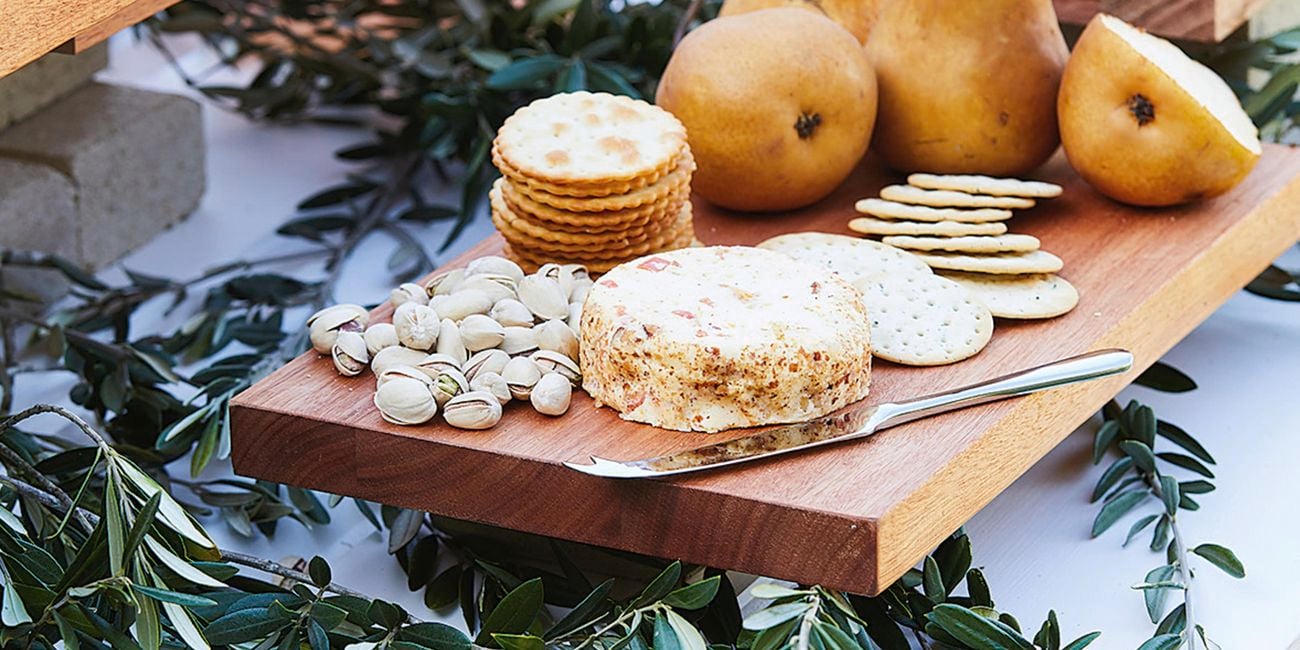 Pears, cheese and pistachio nuts on a grazing board.