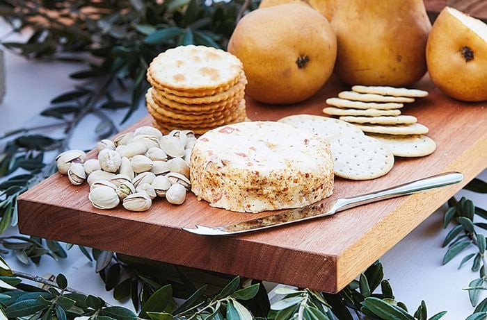 Grazing board with cheese crackers pistachios and pears