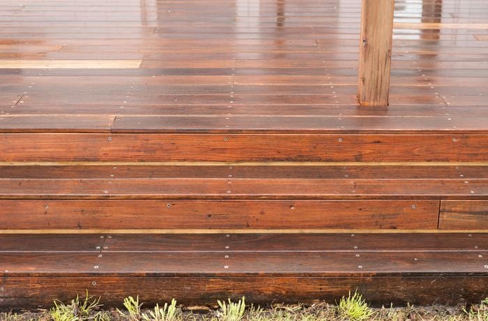 An image of a clean and refreshed timber deck with three steps
