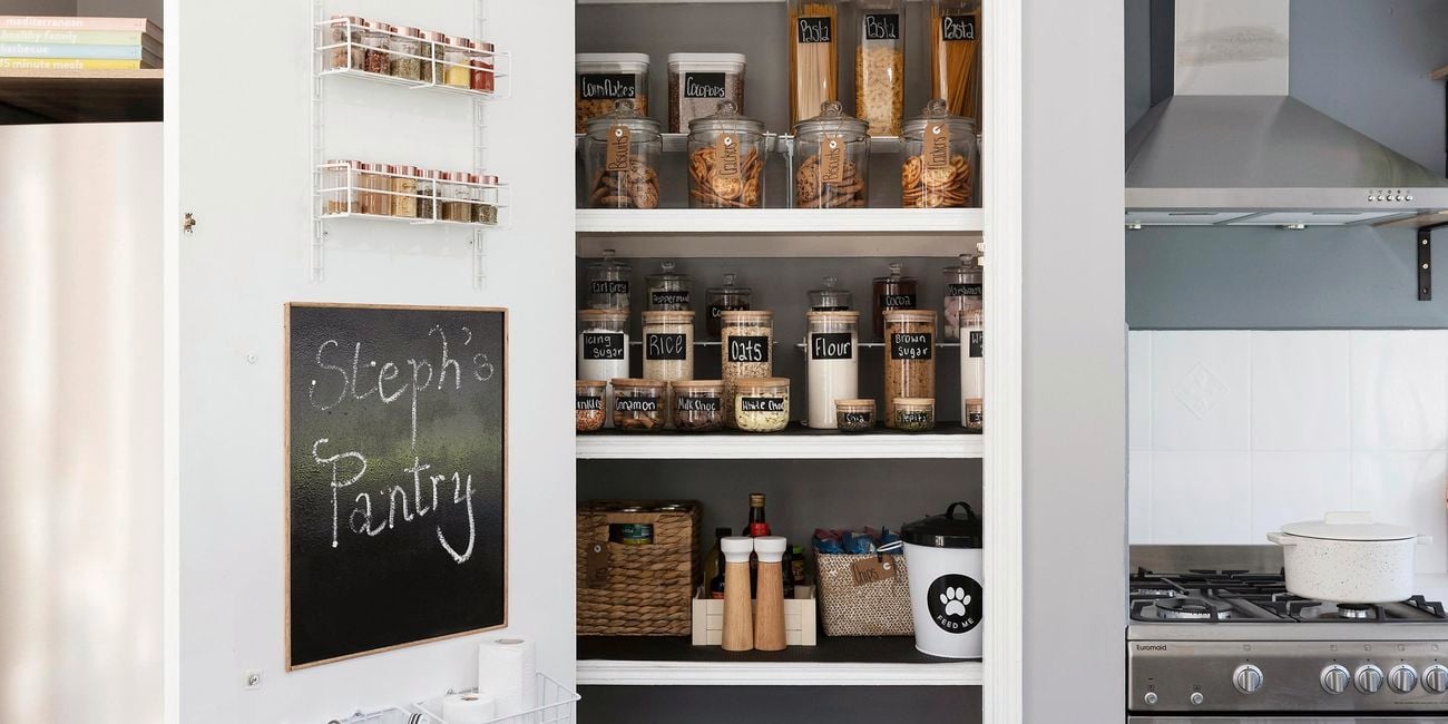 A neatly organised pantry with items in storage containers and baskets